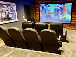 The fully-enclosed theater room contains a 120 inch screen to watch movies & sports.