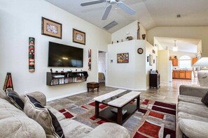 The 65-inch, wall-mounted, flat-screen TV with floating entertainment shelf.