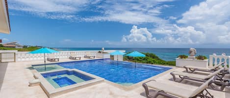 Large pool with hot tub, lounge chairs and umbrellas!
