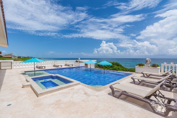 Large pool with hot tub, lounge chairs and umbrellas!
