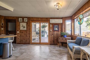 Looking through the kitchen to the patio doors and deck