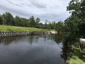 standing in backyard facing bayou