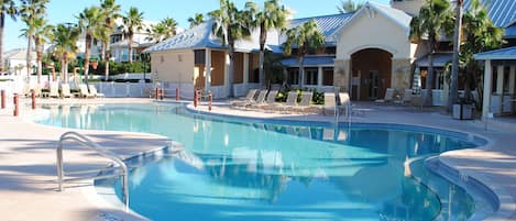 Family pool has beach style zero entry. Lakeside clubhouse in the background.