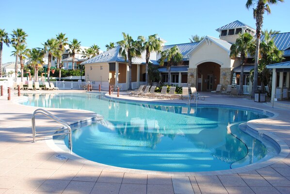 Family pool has beach style zero entry. Lakeside clubhouse in the background.