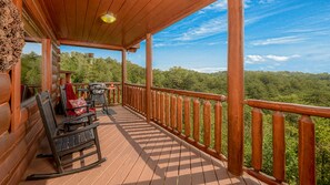 Upper level deck with rockers and a gas grill.