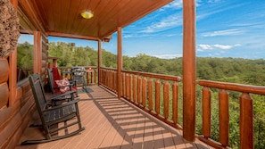 Upper level deck with rockers and a gas grill.