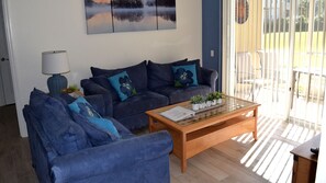 Living room includes sleeper sofa, DVD player, and wall mounted 46” LED TV.