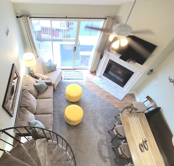 Living room with pull out sofa sleeper and 50" flat screen TV with cable.