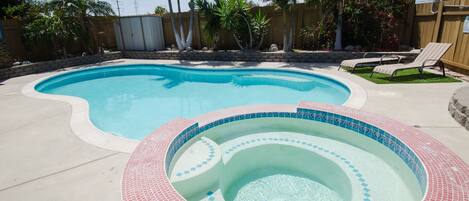 Nice size Backyard with Salt Water pool & jacuzzi!  Solar heated warm pool, electric spa heats up quickly & all controlled via smart phone or provided tablet!