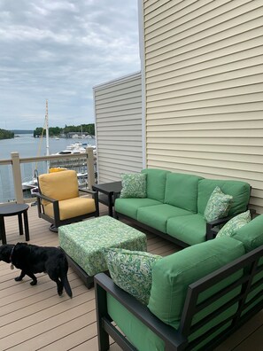 A couch, loveseat and two plush chairs with an ottoman and tables.