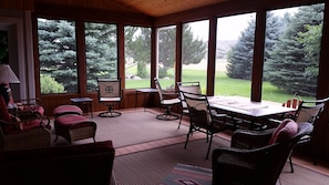 Comfortable patio furniture on screened in porch