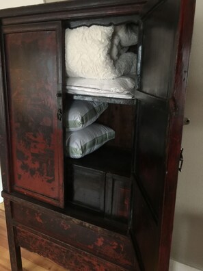 Sofa linens hidden away in this beautiful 18th century chinese cabinet