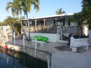 Back side of home , sea wall and kayaks.  large deck overlooking channel. 