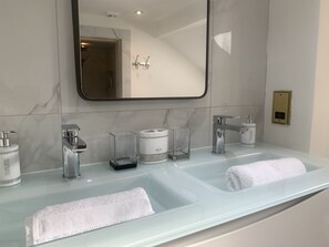 Main bathroom with a double sink, wet room & separate bath