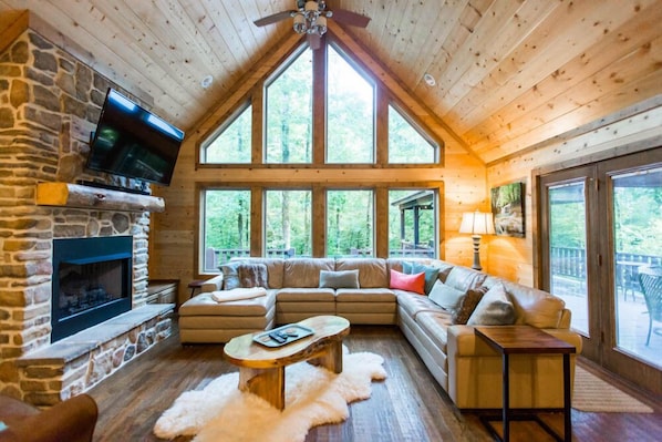 relax in front of the cozy gas-log fireplaces with your favorite beverage and gaze out the wall of windows that frame the beautiful forest.