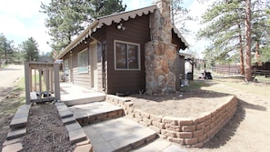 Back yard has pergola and gas grill for your evening BBQ.