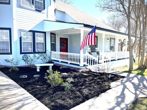 Large front porch with rocking chairs and porch swing 