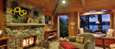 Cozy interior,  wood  fireplace, spectacular water views and picture window seat