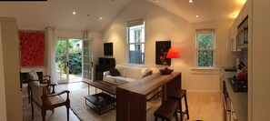 Living Room with Queen size Pull out Sofa, Custom Dining Table and Fully Equipped Kitchenette