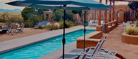 Chaise lounges with umbrellas for lazy pool side days!