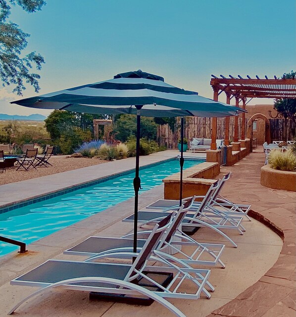 Chaise lounges with umbrellas for lazy pool side days!