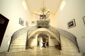 The double-sided marble staircase in the entryway makes for a grand welcome!