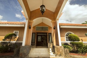 An elegant circluar drive featuring a water fountain leads you to the front door