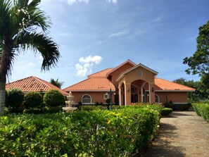 An elegant circluar drive featuring a water fountain leads you to the front door