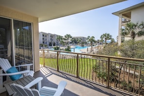 Living room balcony with view of pool and beach