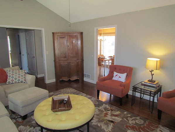 Living area with vaulted ceilings and comfy sofa and chairs