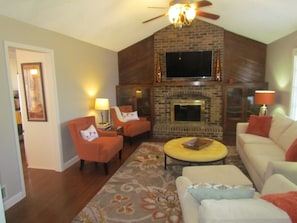 Another view of living area with fireplace and 55" SMART tv