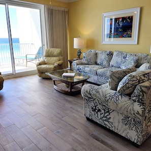 Your comfy living room opens out to the beachfront balcony!