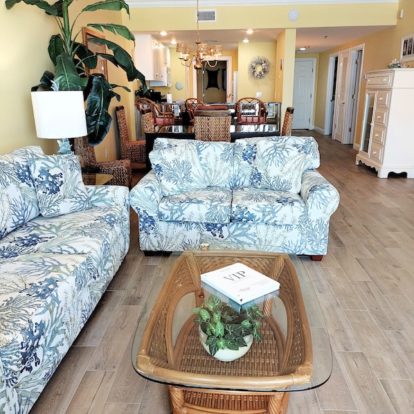 A view of the living room, dining room, wet bar and kitchen.