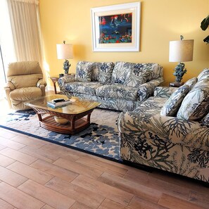 Your comfy living room opens out to the beachfront balcony!