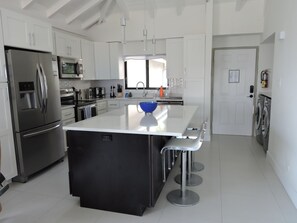 Kitchen and Full sized modern washer and dryer