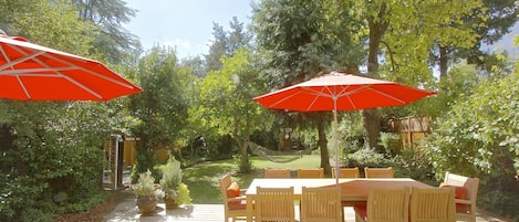 The outside deck, an oasis with table for 10, chaise loungers, and hammock.