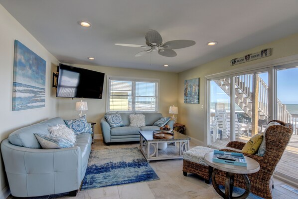 High-end furniture adorns the living room topped off with a 65" Samsung smart TV