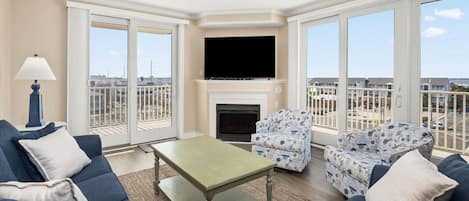 Beautiful living room with lots of natural light and views of the bay!