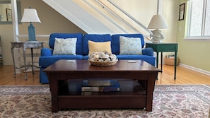 Comfy couch and stairs leading to master suite.
