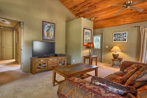 A cozy living room with a couch and TV.