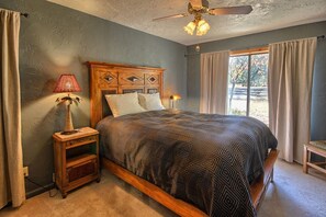 The second bedroom with a queen bed, private A/C, and a large window. 