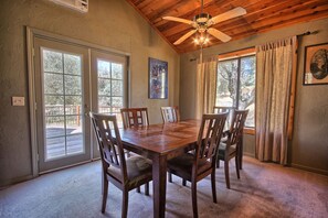 Dining area with a 6-seater table and beautiful views through large windows.