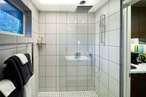 Walk-in rain shower with additional hand-held shower. Heated towel rack.