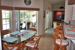 Views of the pool while preparing meals and plenty of seating area inside & out.