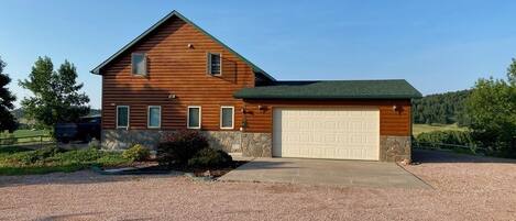 House with driveway view. Garage and outside parking.