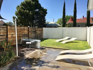 Private backyard with turf grass and ranch swim tank.