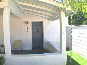 Front entry w/ lush lawn and covered porch. Sit & watch the action on Texas St!