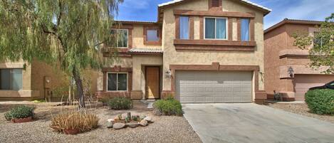 2 story home with desert landscape