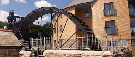 Outside the apartments and the restored waterwheel