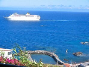 Watch the ships sail past in the evening with a glass or two